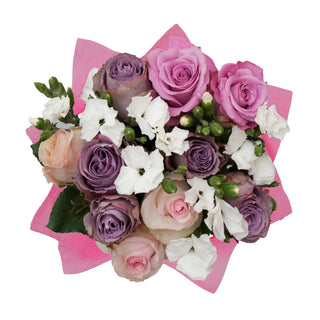 Purple and light pink roses, white and green filler flowers bouquet